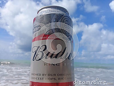 MACEIO, AL, BRAZIL - May 12, 2019: Budweiser cold beer and a beautiful sky and sea behind Editorial Stock Photo