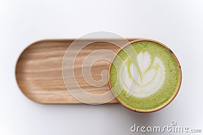 Macha Latte Cup on a Wooden Plate Isolated. Stock Photo