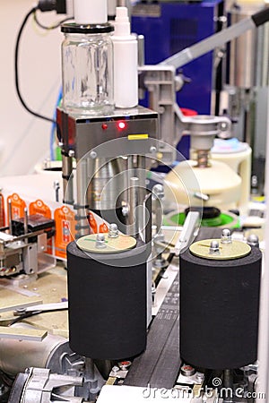Machine for applying self-adhesive labels. The machine is designed for automatic labeling on a cylindrical container Stock Photo