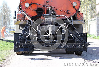 Machine for asphalt road with liquid black bitumen in the tank Stock Photo