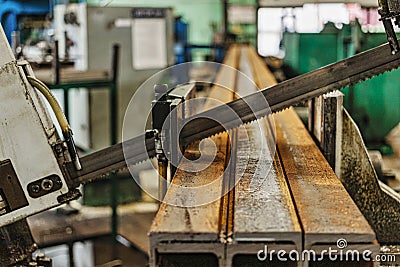 Machine for cutting metal profile. The saw cuts metal blanks into pieces. Industrial equipment for cutting and processing metal Stock Photo