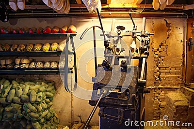 Machine for manufacturing wooden shoes Klompen in Holland. National traditional Dutch wooden shoes. Clog and Klomp Production Stock Photo