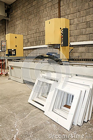 A machine mass-produces pvc frames for window construction Stock Photo