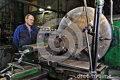 Machine tool workshop in factory metalworking operator controls Editorial Stock Photo