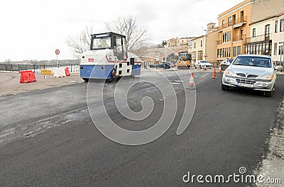 Machines performing asphalting and paving work on a city road. Editorial Stock Photo