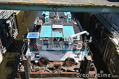 Passage of a thrust boat through a historic lock on the waterway `Teltowkanal` near Berlin Editorial Stock Photo