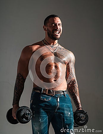 Macho confident face with muscular body sportsman bodybuilder. Muscular macho six packs hold dumbbells. Guy attractive Stock Photo