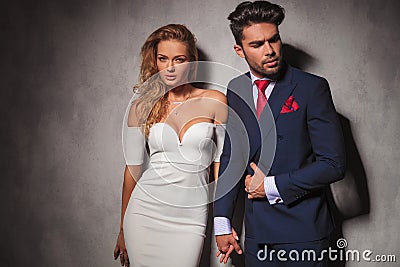 Macho fashion elegant man holding his lover by her hand Stock Photo