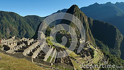 Machu Picchu in Peru - lost city of Incan Empire is UNESCO heritage. Sunny summer day with blue sky. Stock Photo