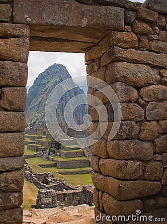 Machu Picchu view of the mountain and the ruins through the doorway Stock Photo