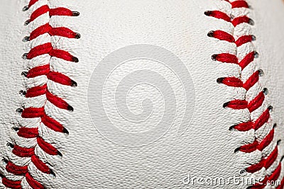 A macro of a baseball with red stitching and room for copy on the ball Stock Photo