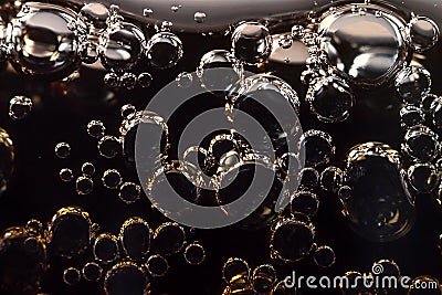 Macro black bubbles on the glass wall of cola Stock Photo