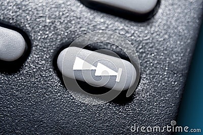 Macro Of A Black Skip Forward Button On Black Remote Control For A Hifi Stereo Audio System Stock Photo