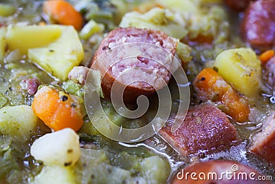 Macro close up of german hearty pea stew with potatoes, leek, carrots and smoked sausages - Germany Stock Photo