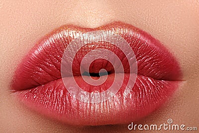 Glamour fashion bright red lips make-up with gold glitter. Macro of woman`s face part. Sexy lip makeup, luxury visage Stock Photo