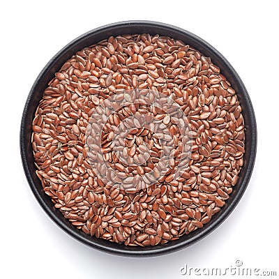 Macro Close up of Organic Brown flaxseeds Linum usitatissimum or linseed on a black ceramic bowl , Stock Photo