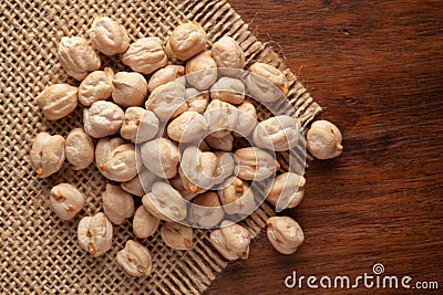 Macro Close-up of Organic Chole Chana or Kabuli Chana Cicer arietinum or whole white Bengal Gram Dal on Jute mat and wooden Stock Photo