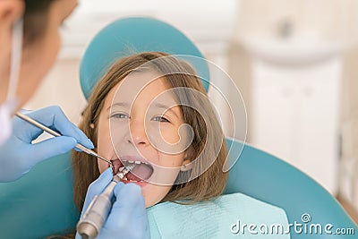 Macro close up of young child with open mouth at dentist. Teeth checkup at dentist& x27;s office. Dentist examining girls teeth in Stock Photo