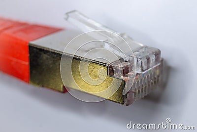 Macro cross section front angle view of red RJ45 CAT6 shielded network data internet cable clear connector Stock Photo