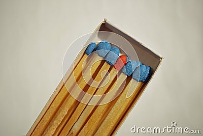 Macro detail of a box of matches matchbox full of matches with blue top and one different with a red top Stock Photo