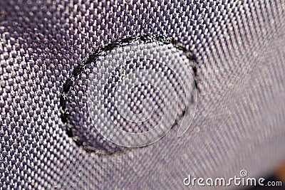 Macro detail of a circle made of stitched thread on the glossy fabric Stock Photo