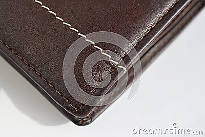 Macro detail of a white and brown thread stitching black and brown stitched leather wallet Stock Photo