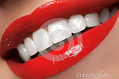 Macro happy woman's smile with healthy white teeth, bright red l Stock Photo