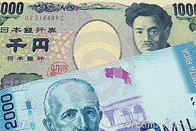 A Japanese thousand yen note paired with a colorful two thousand colones bank note from Costa Rica. Stock Photo