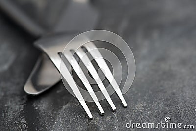 Macro image of knife and fork on rustic background Stock Photo