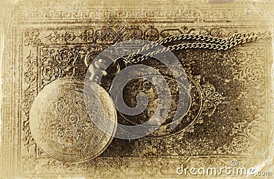 Macro image of old vintage pocket watch on antique book. top view. retro filtered image, old style photo Stock Photo