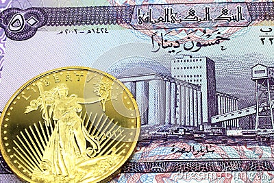 A purple fifty dinar note from Iraq with a gold coin in macro Stock Photo