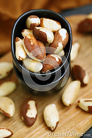 Macro. Large brazil nuts in a bowl. Peeled nuts Stock Photo