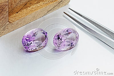 Macro mineral faceted stone cut Amethysts on a gray background Stock Photo