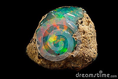 Macro mineral stone rare and beautiful opals on a black background Stock Photo