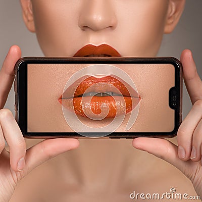 Macro perfect lip makeup. Macro photograph of the details of the face. Lipstick shades of orange. Stock Photo