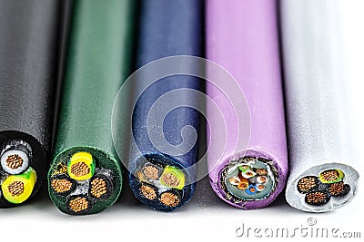 Macro photo of the cross section of various electric cables, isolated on a white background. Stock Photo