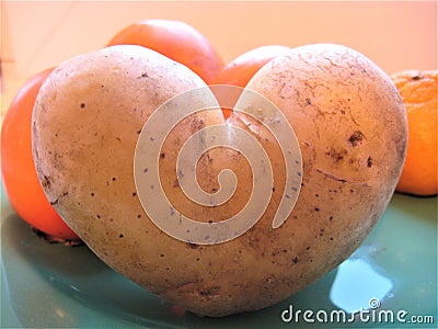 Macro photo with a decorative background of a figured potato vegetable in the shape of a heart Stock Photo