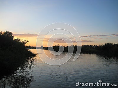 Macro photo with decorative background of rural sunset landscape on the river in beautiful gentle evening shades of light Stock Photo
