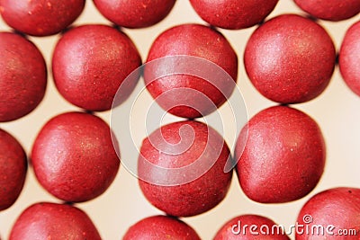 Macro photo of many red ball-shaped pills. Tibetan folk medicine from the herbal complex. Stock Photo