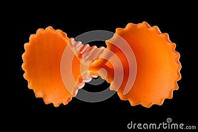 Macro photo of orange farfalle pasta isolated on black with clipping path Stock Photo