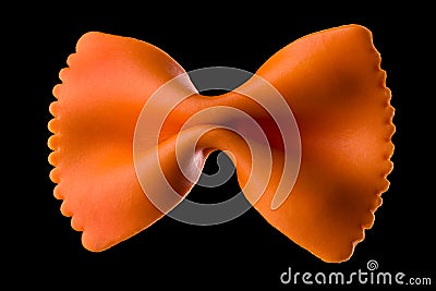 Macro photo of orange farfalle pasta isolated on black with clipping path Stock Photo
