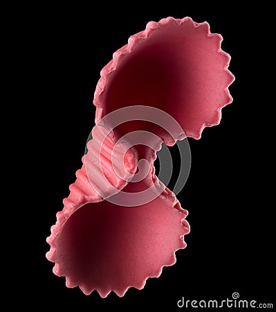 Macro photo of pink farfalle pasta on black with clipping path Stock Photo