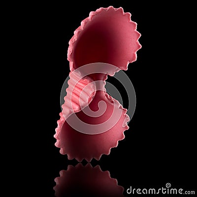 Macro photo of pink farfalle pasta isolated on black with clipping path Stock Photo