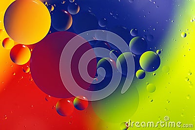 Macro photography of the drops on the water surface.Multicolored vibrant background.Cosmic circles looks like molecula structure. Stock Photo