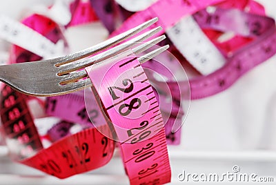 Macro pink tape measure on fork Stock Photo