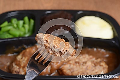 Macro salisbury steak on a fork tv dinner Stock Photo