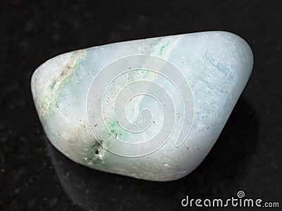 polished green Aragonite gemstone on dark Stock Photo