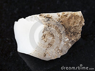 raw cacholong (white opal) stone on dark Stock Photo