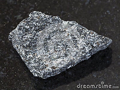rough nepheline syenite stone on dark Stock Photo