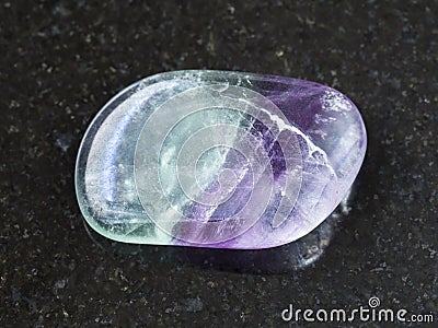 tumbled Fluorite gem stone on dark background Stock Photo